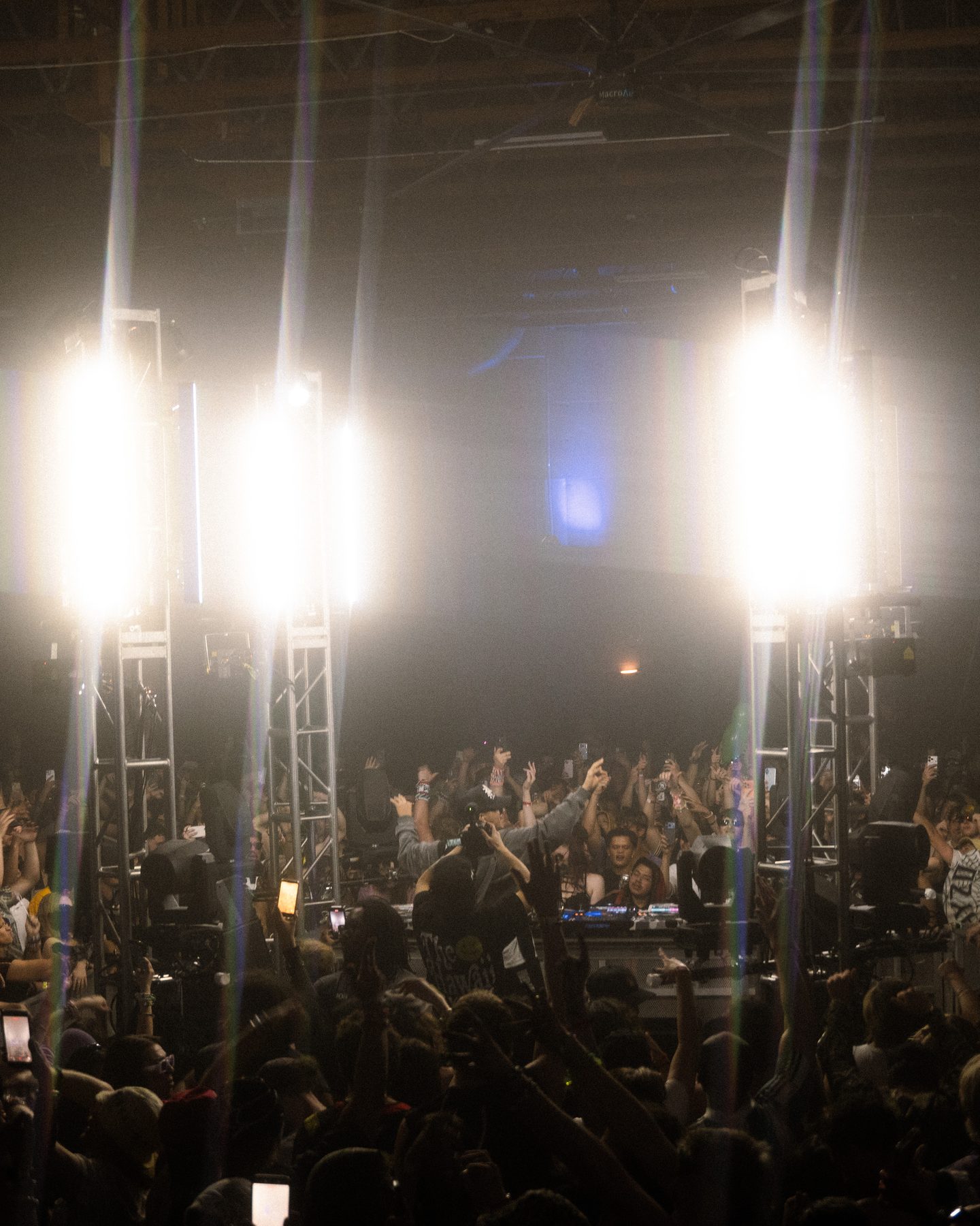 Crowd with hands up under lights