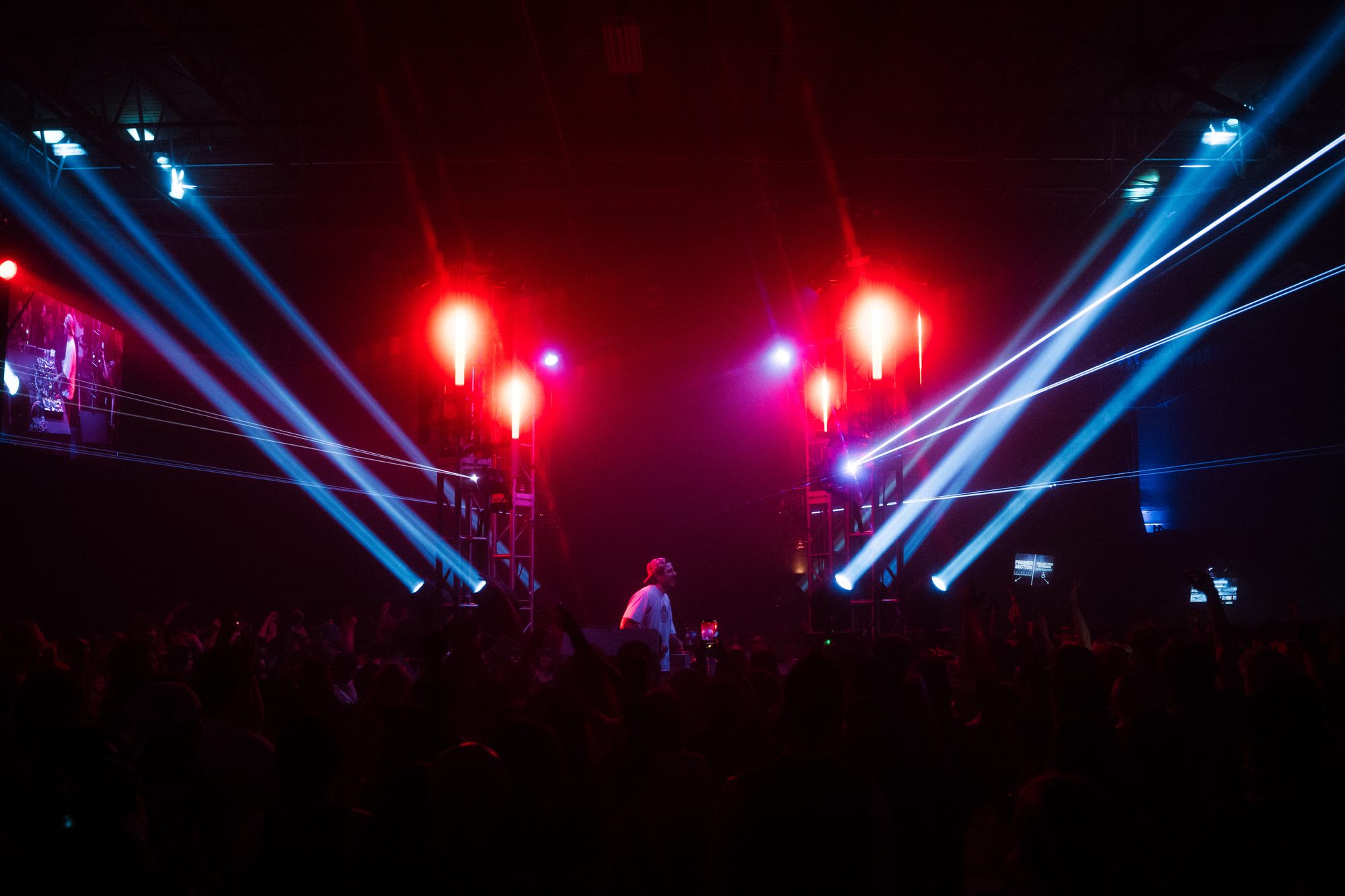 Artist behind decks, spotlights and light bars